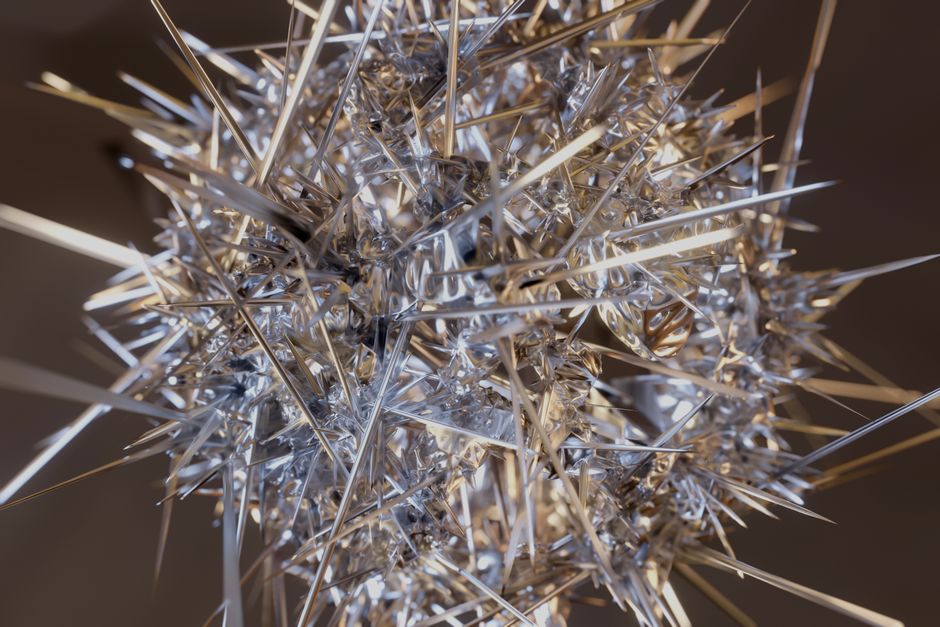 Intricate 3D rendered abstract with silver spikes creating a dramatic visual impact.
