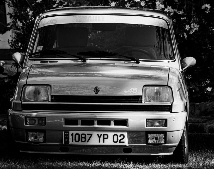 Classic Renault car front view in black and white, showcasing vintage design.