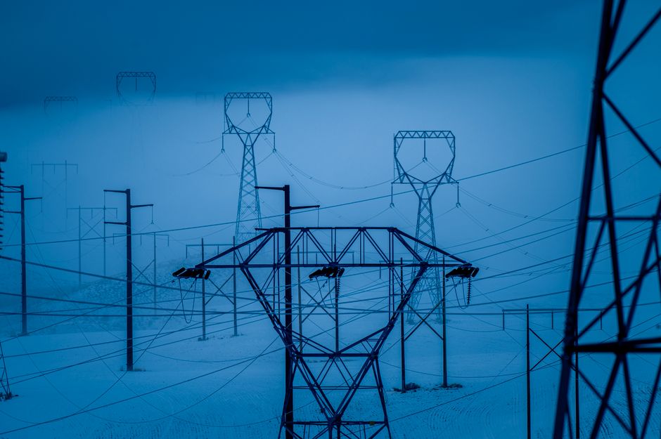 Transmission towers in snowy East Wenatchee, WA, during winter, showcasing electrical infrastructure.