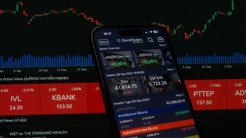 Close-up of a digital stock trading app interface with investment charts and market trends displayed.