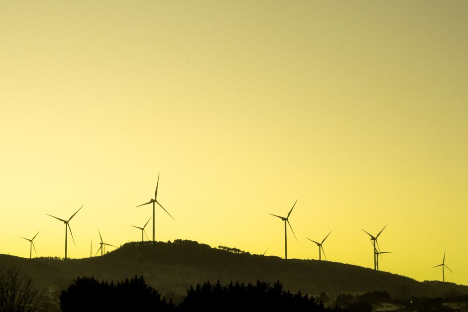 Silhouette of wind turbines on a hill during a yellow sunset in Istanbul, Turkey.