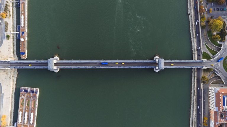 A stunning aerial view of a bridge across the Danube River in Budapest, Hungary, showcasing urban architecture.