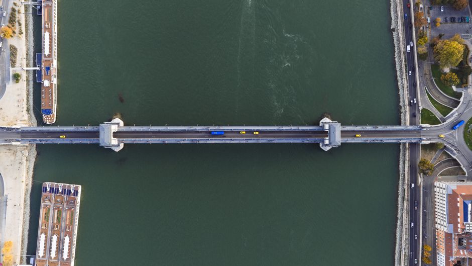 A stunning aerial view of a bridge across the Danube River in Budapest, Hungary, showcasing urban architecture.