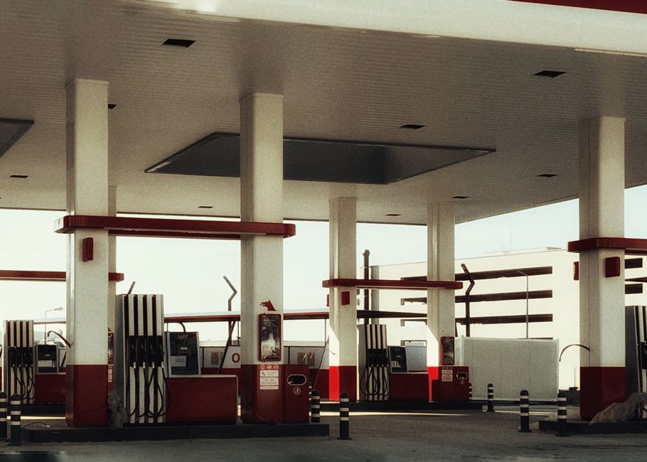 Brightly lit modern gas station featuring multiple fuel pumps and a distinct red and white design.