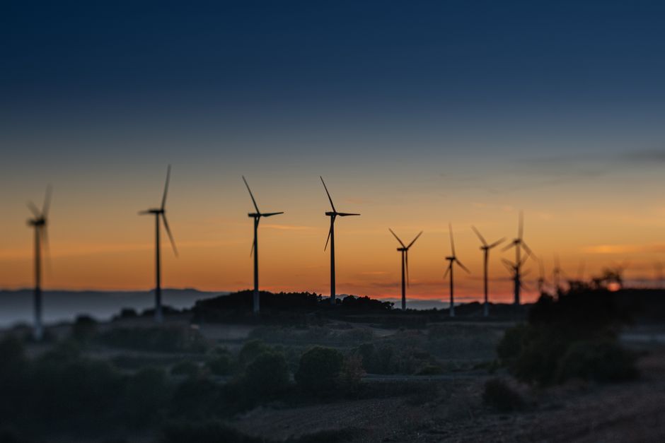 Scenic view of a wind farm in Lleida, Spain during a vibrant sunset.