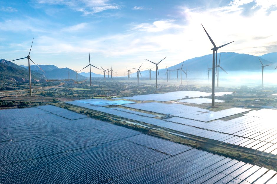 Dramatic aerial shot showcasing a wind farm and solar panels in Vietnam, illustrating the potential of renewable energy sources.