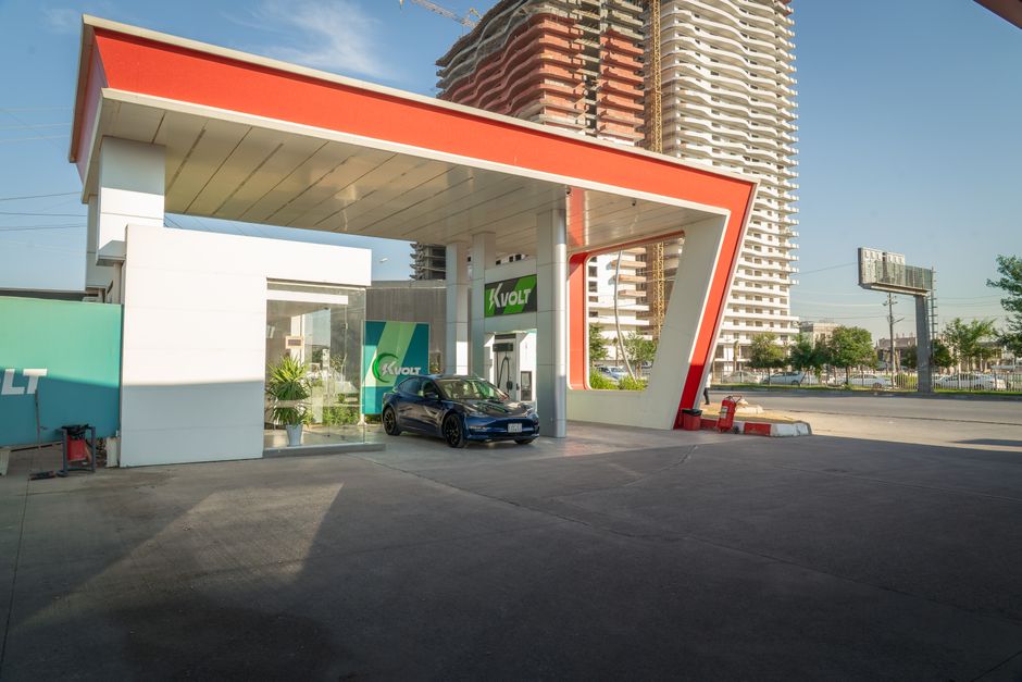 Electric vehicle at a modern charging station in an urban setting, promoting sustainability.