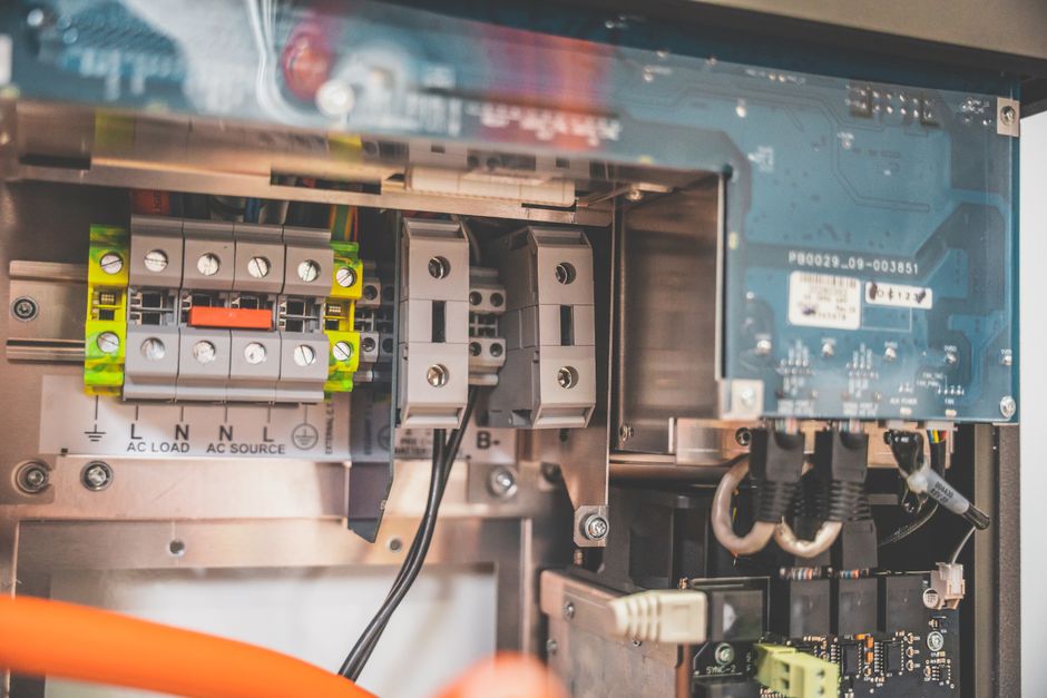 Close-up view of the internal components of a solar inverter showing electrical parts.