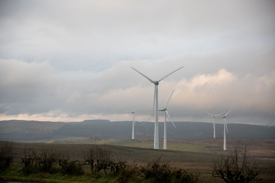 Majestic wind turbines in the serene UK countryside generate renewable energy.