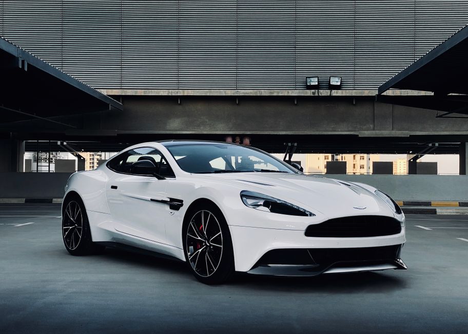 A sleek white sports car parked in a modern urban environment, showcasing elegance and design.
