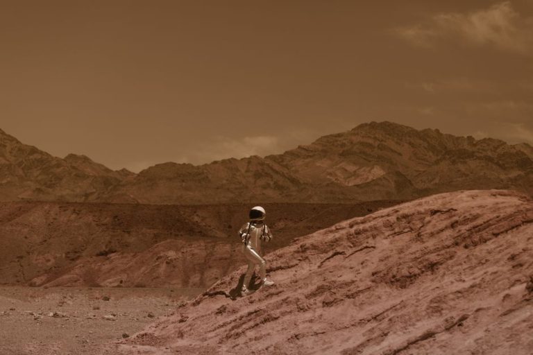 Astronaut walking on a barren landscape resembling Mars, with futuristic and adventurous vibes.