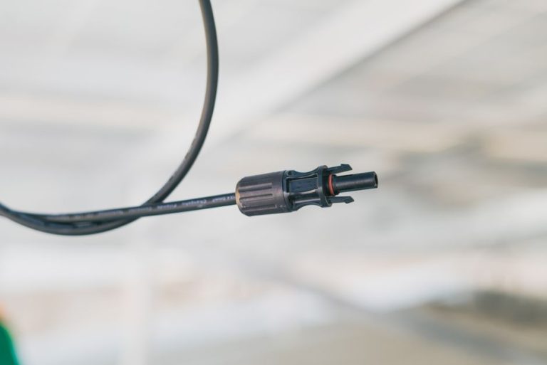 Detailed close-up shot of an electrical connector cable with a blurred background.