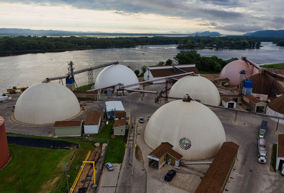 Aerial view of industrial domes by the river in Winona, MN, showcasing infrastructure and water.