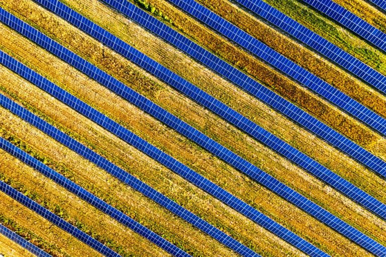 Vibrant aerial shot of solar panels in a field, showcasing renewable energy in Red Wing, MN.
