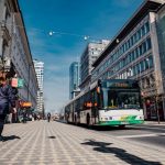 Street scene in Ljubljana featuring public transportation bus and pedestrians.
