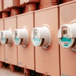 Close-up view of a row of industrial electricity meters for power monitoring and technology.