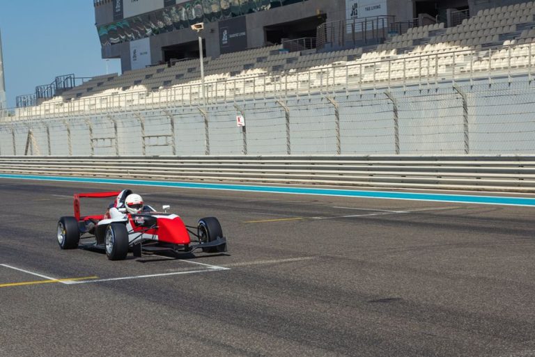 Formula car speeding on the track at Yas Marina Circuit in Abu Dhabi, UAE.