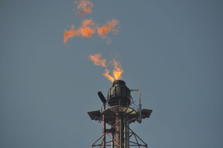 Flare stack releasing flames at an industrial site in Kerteh, Malaysia.