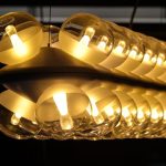 Artistic view of glowing pendant lights with stunning reflection and ambient design.