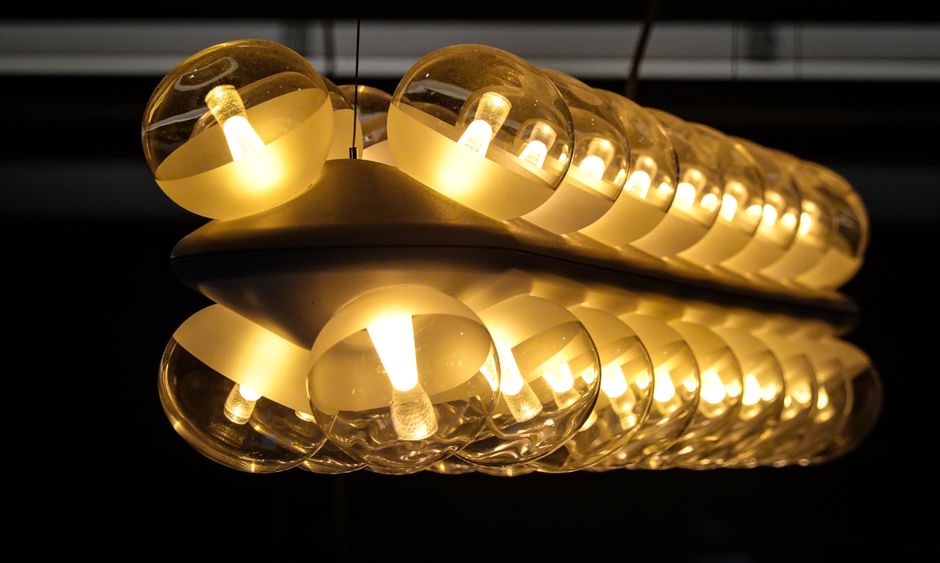 Artistic view of glowing pendant lights with stunning reflection and ambient design.