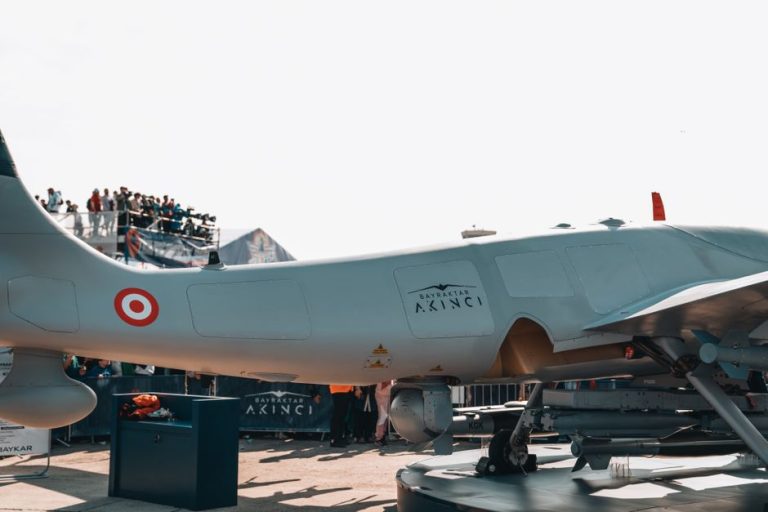 Bayraktar Akinci drone displayed at a busy airshow with spectators.