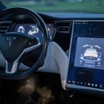 Interior shot of a modern electric car showcasing a sleek design and advanced touchscreen technology.