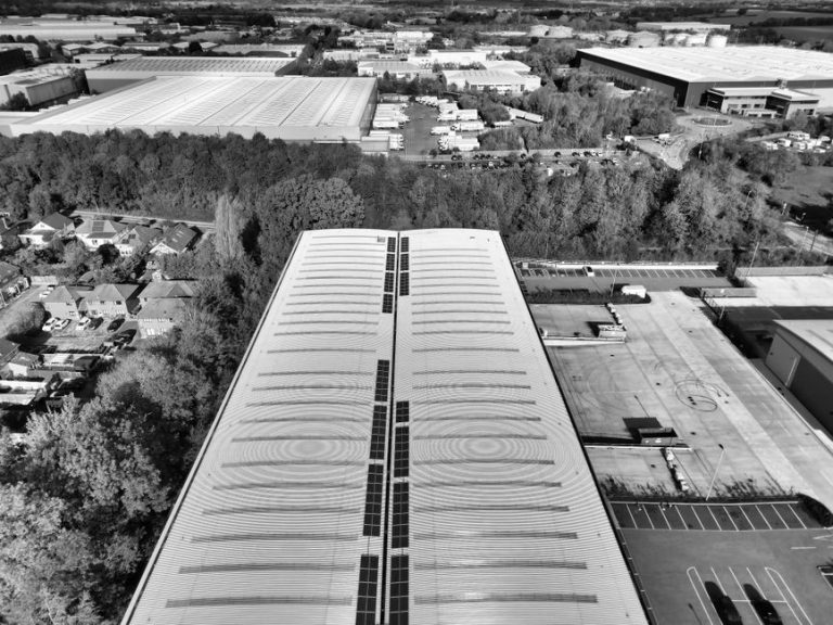 Black and white aerial shot of Hertfordshire warehouses and surrounding greenery.
