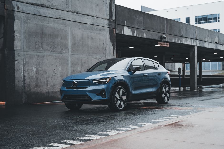 Blue Volvo SUV parked in a modern urban environment showcasing sleek design and urban lifestyle.