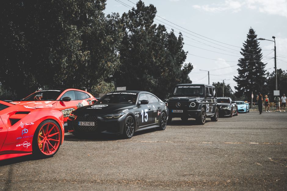 A lineup of luxury sports cars at an outdoor auto show in Arad, Romania.