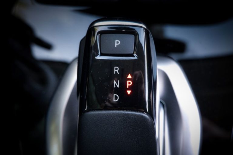 Detailed view of a modern automatic car gear shifter displaying P, R, N, D settings.