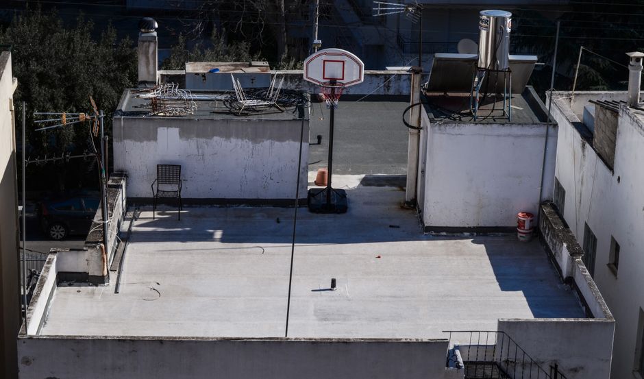 Rooftop basketball hoop on a concrete surface in Athens, Greece.