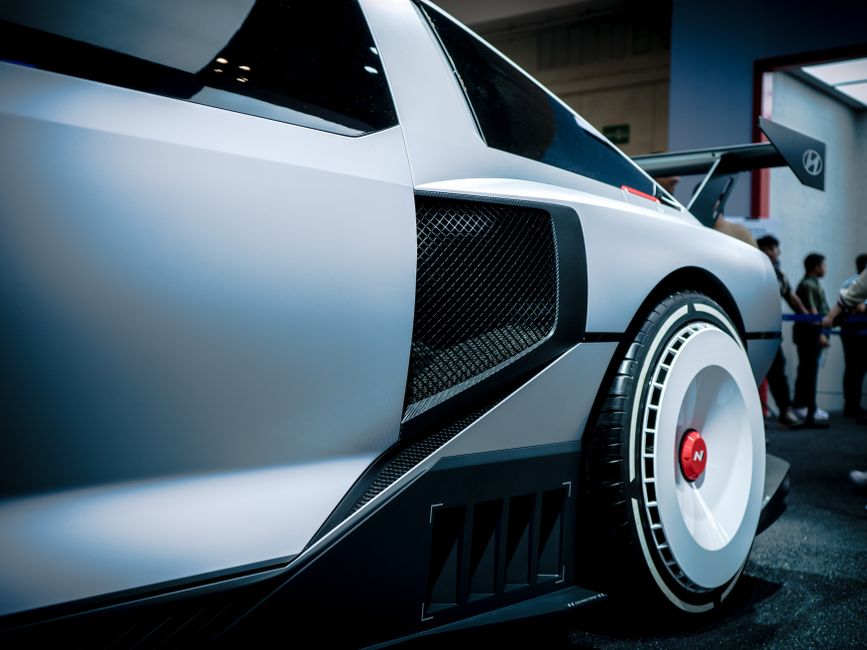 Close-up of a Hyundai concept car showcased in an indoor exhibition with modern design details.