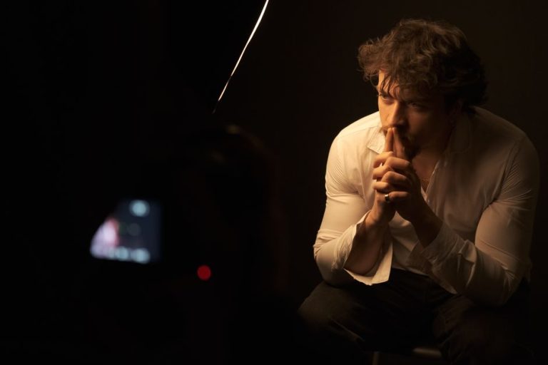 Dramatic portrait of a man in deep thought, studio lighting.