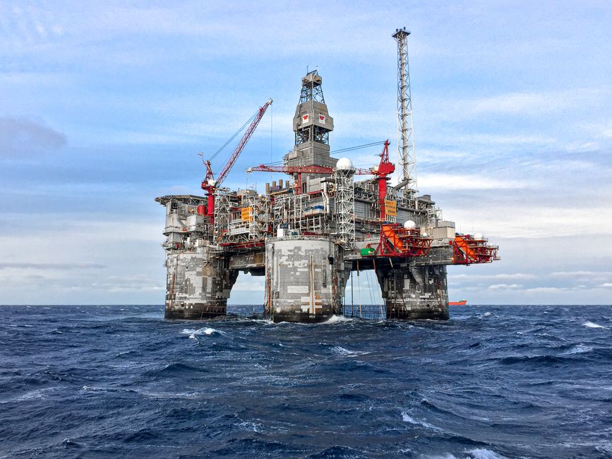An offshore oil platform in Norway's North Sea under a clear blue sky.