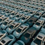 Overhead view of neatly arranged cars in a Libyan parking lot, captured at day.