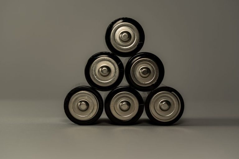 Metallic AA batteries stacked in a pyramid shape, symbolizing power and energy storage.
