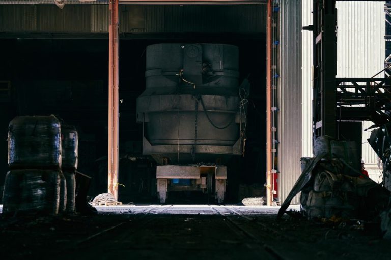 Interior shot of an industrial factory showing large machinery and metal structure.