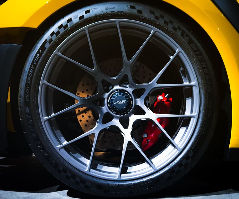 Detailed view of a sports car wheel and brake system featuring a RS rim, perfect for automotive enthusiasts.