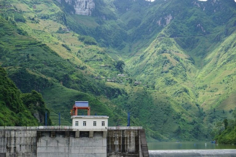 Scenic view of a hydroelectric dam nestled in the lush mountains of Meo Vac, Vietnam.