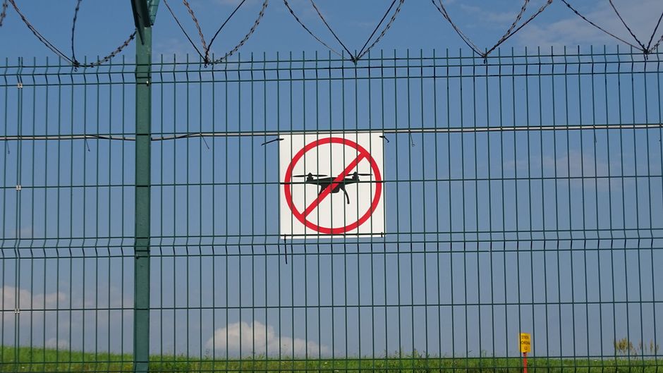 A 'No Drones' sign on a barbed wire fence in Morawica, Poland.