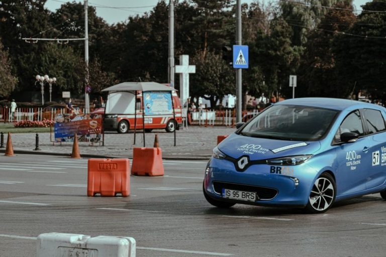 Blue car driving on asphalt race track in city center while racing rally