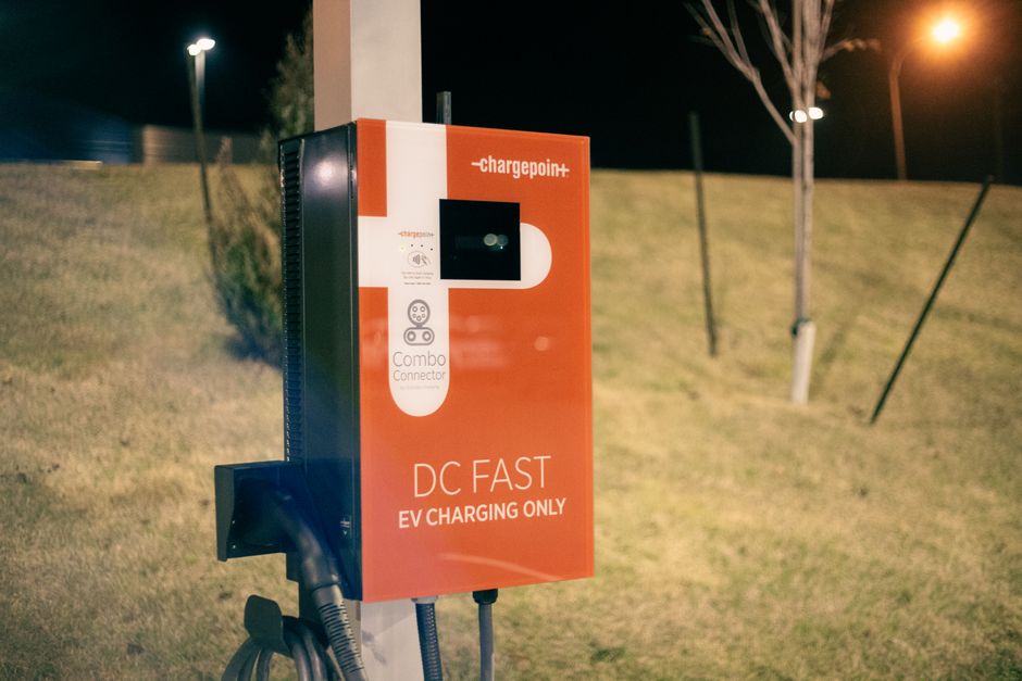 Electric recharging point for vehicles working on eco friendly energy source against hill on roadside at night