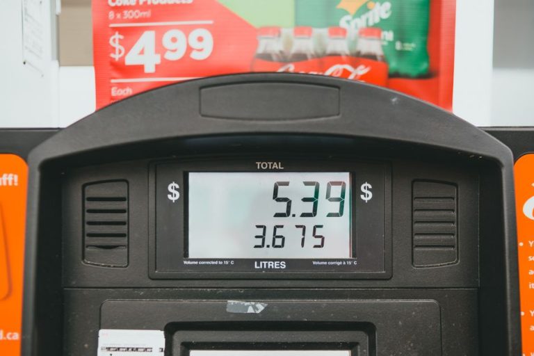 Close-up of a gas pump display showing price per liter and total volume during a transaction.