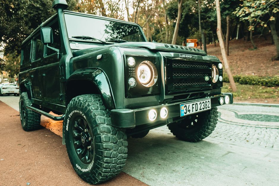 A rugged Land Rover Defender SUV parked on a street in Istanbul, showcasing its robust design.
