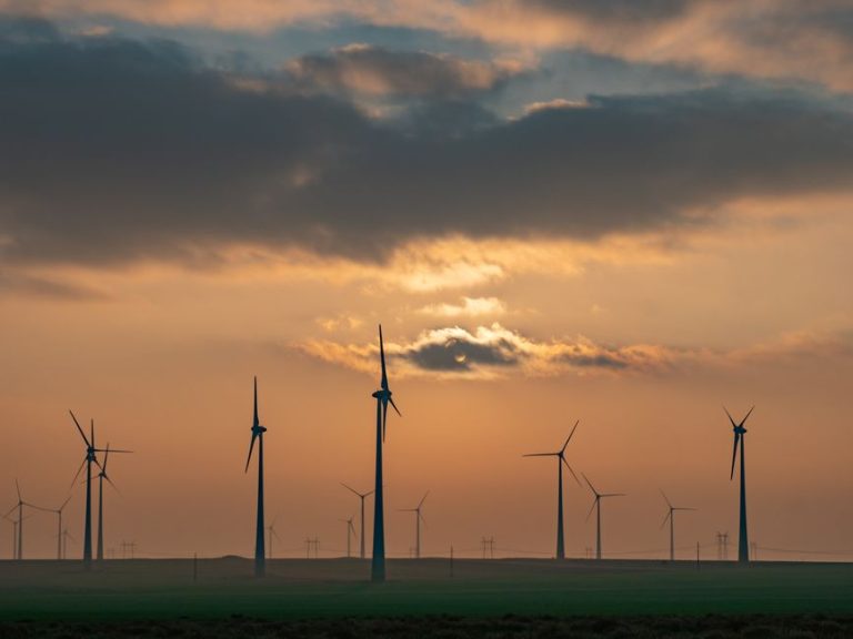 Scenic view of wind turbines at sunset in Romania, showcasing alternative energy sources and sustainability.