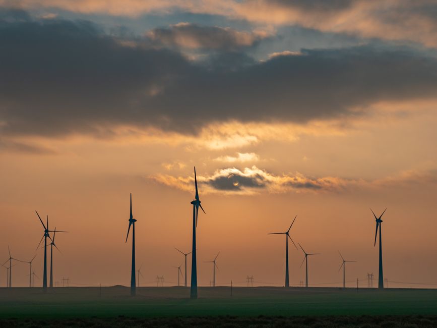 Scenic view of wind turbines at sunset in Romania, showcasing alternative energy sources and sustainability.