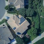 An aerial view showcasing modern suburban houses equipped with solar panels for renewable energy.