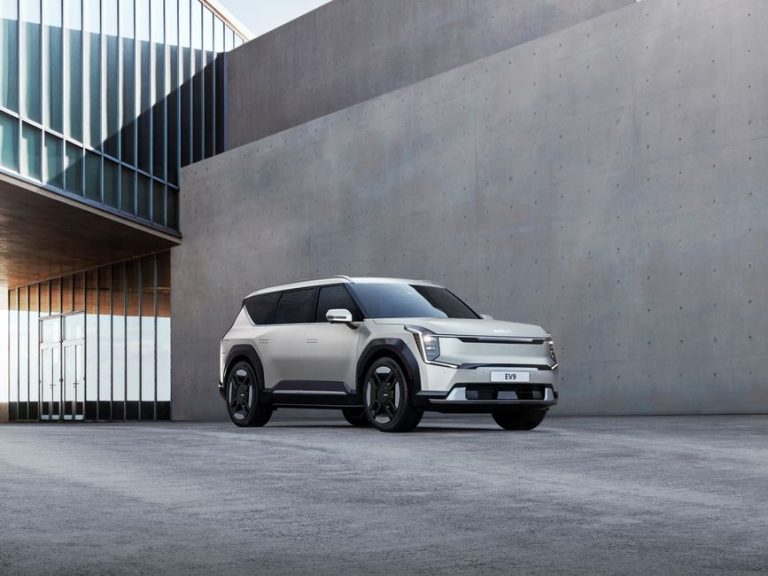 Kia EV9 electric SUV parked in an urban architectural environment, showcasing modern design.