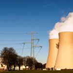 A nuclear power plant in Hameln, Germany, showcasing cooling towers and electricity pylons.