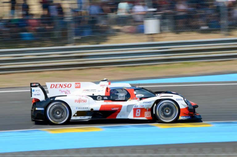 Dynamic Toyota Hybrid racing car in action at the 24 Hours of Le Mans, showcasing speed and precision.